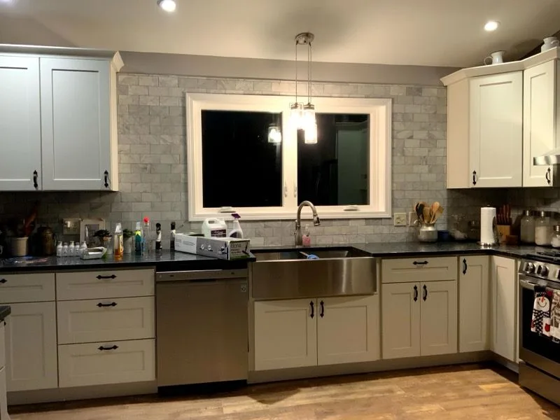 Complete kitchen remodel with soft-gray cabinets, dark counters, stainless appliances and tile backsplash in Milford, Ohio