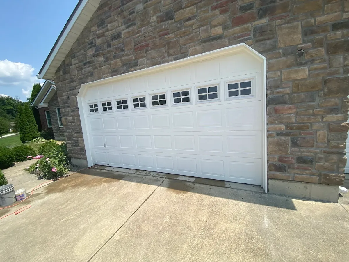 New white paneled garage door installed on a stone-faced home in Batavia, Ohio