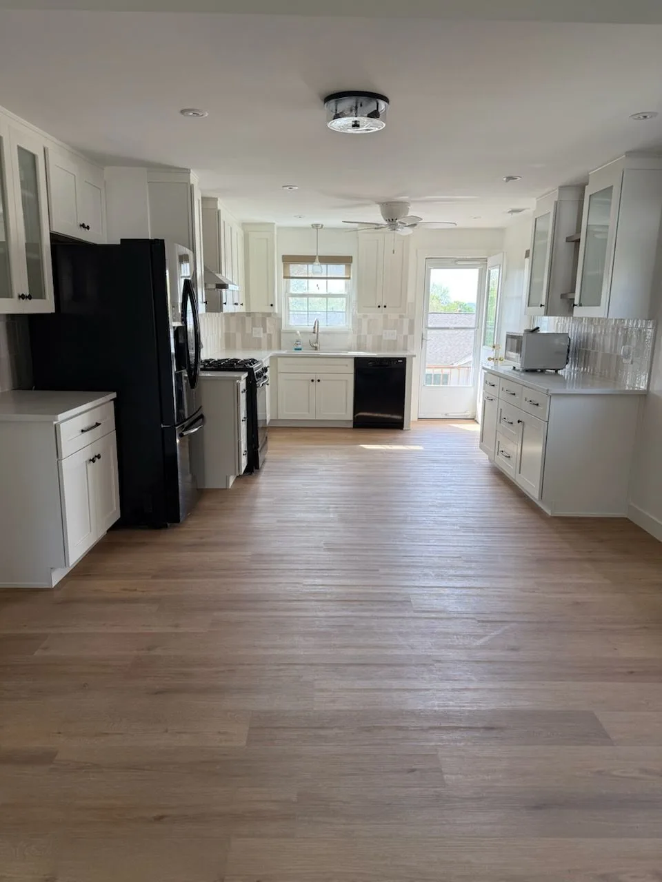 Built-in white cabinetry with glass upper doors and coffee bar station in a Cincinnati, Ohio kitchen remodel
