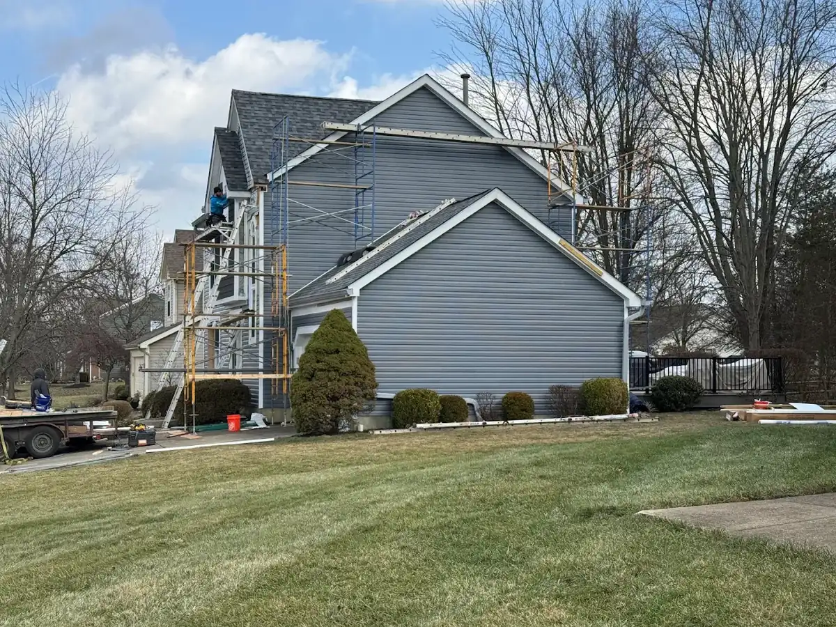 Scaffolding set for a full vinyl siding replacement on a two-story home in Eastgate, Ohio