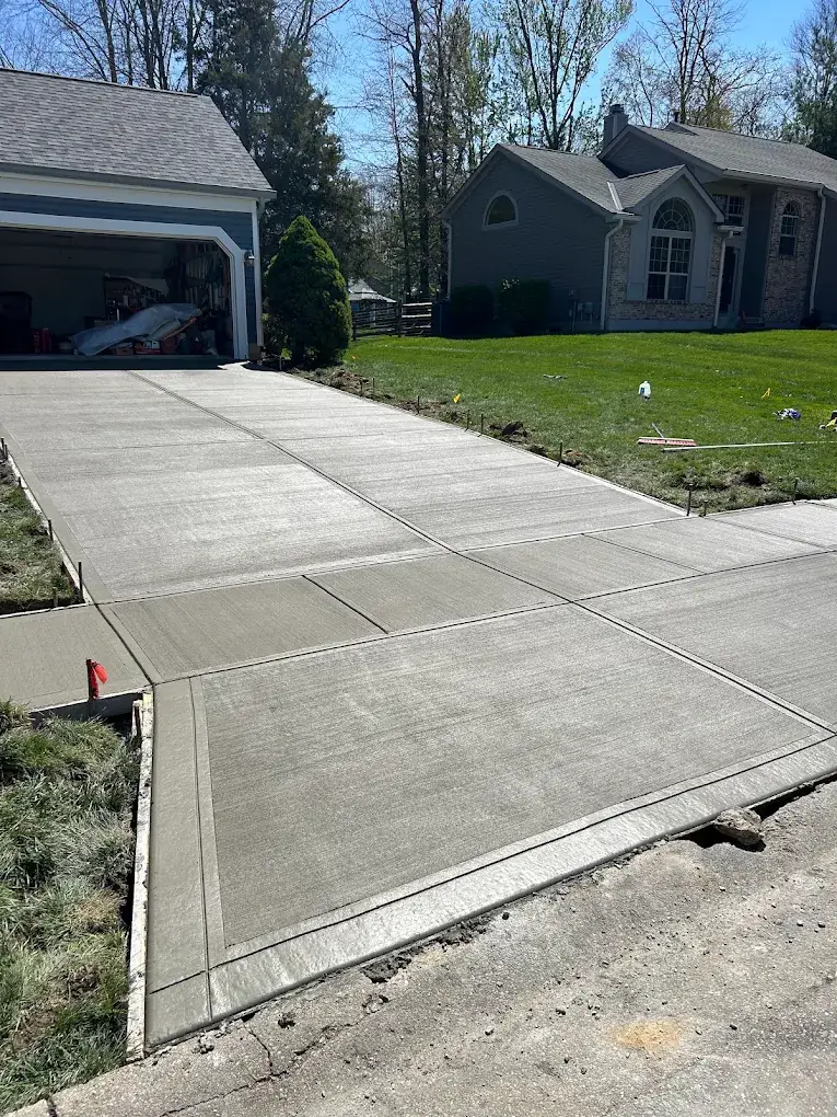 Newly poured broom-finished concrete driveway with borders in Loveland, Ohio by Abrams Restoration